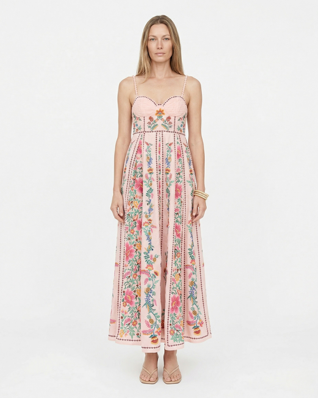 Woman wearing a floral pink dress on a white background