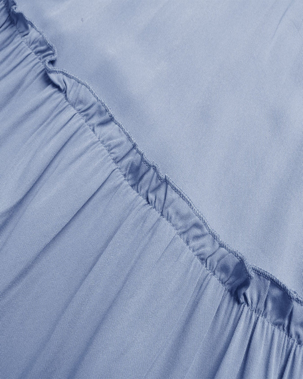 Close-up of a light blue fabric with ruffled edge