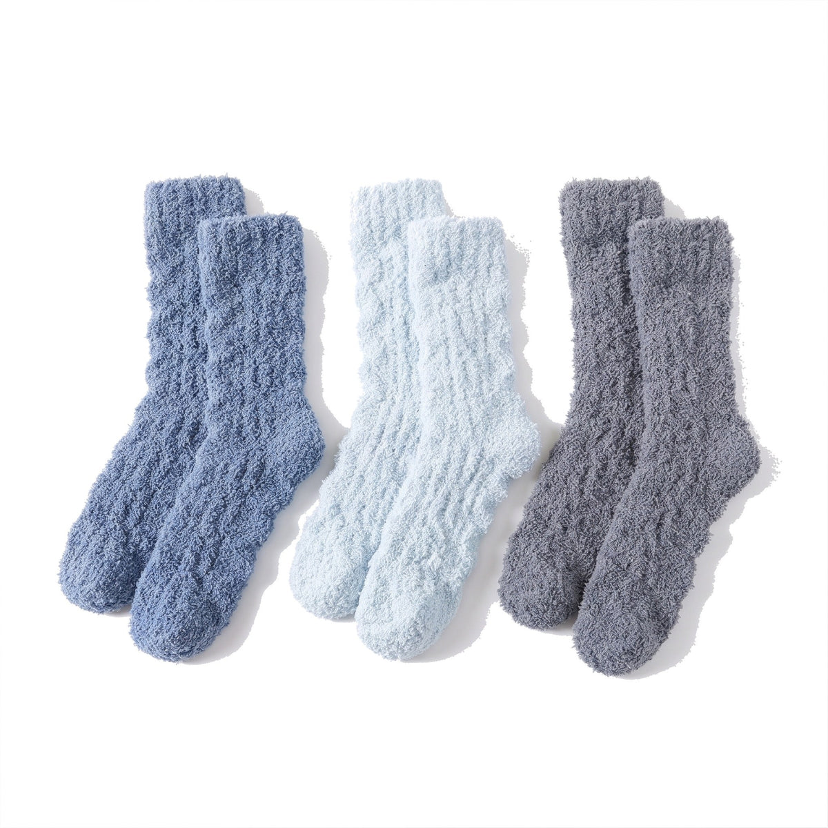 Three pairs of fluffy bed socks in denim blue, light blue and grey