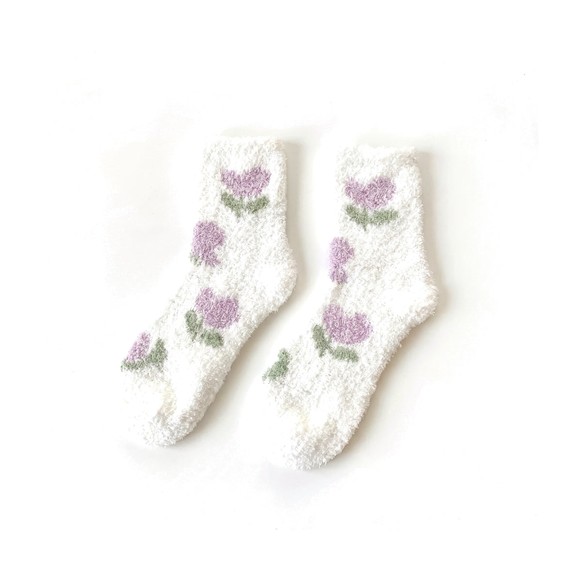 White fluffy socks with lilac tulip pattern laid flat