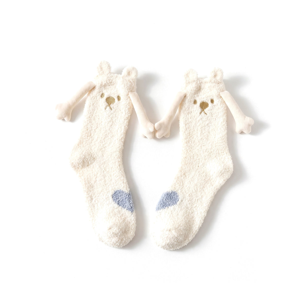 Cream Bear fluffy hand holding socks laid flat with magnetic hands touching