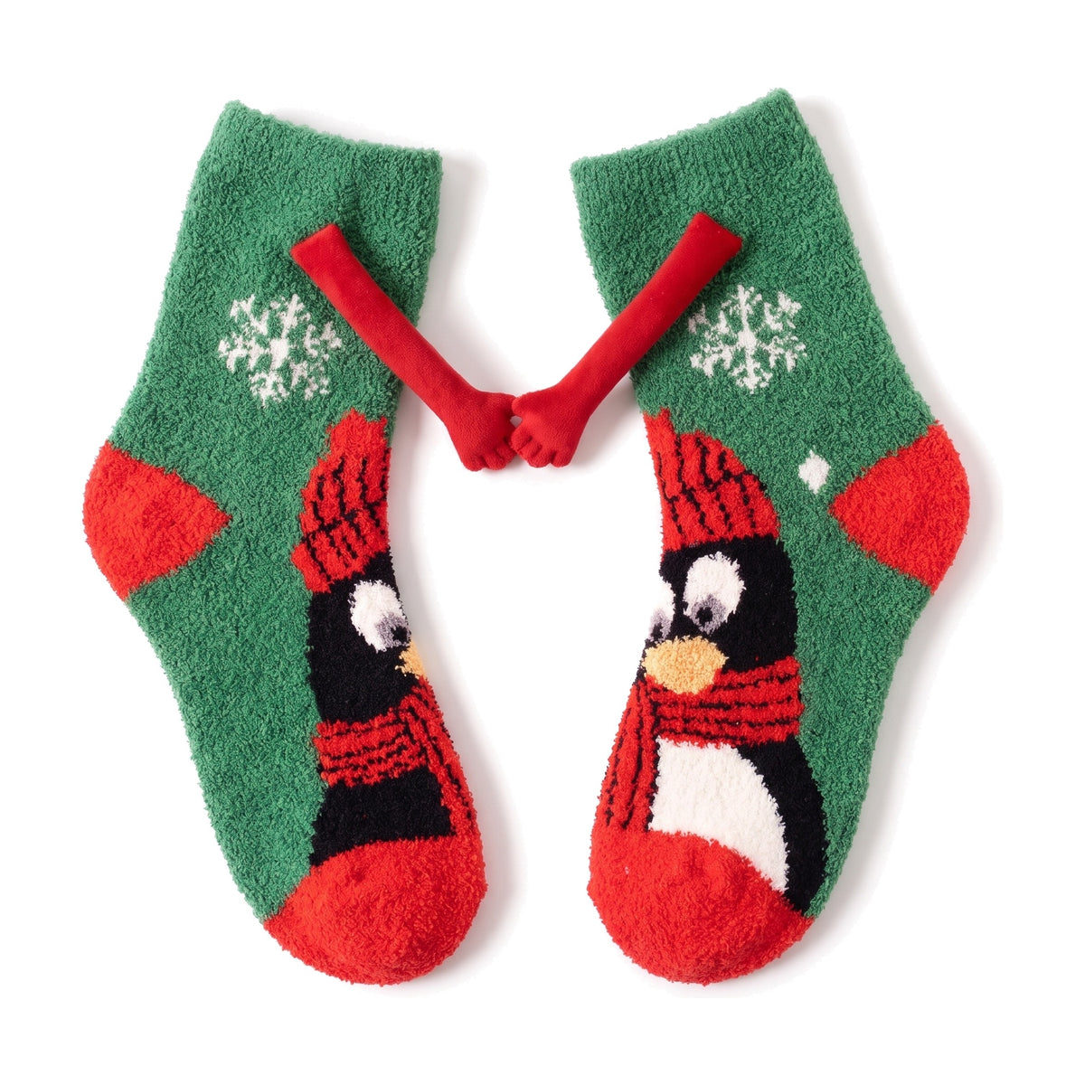 Penguin fluffy hand holding socks laid flat with magnetic hands touching