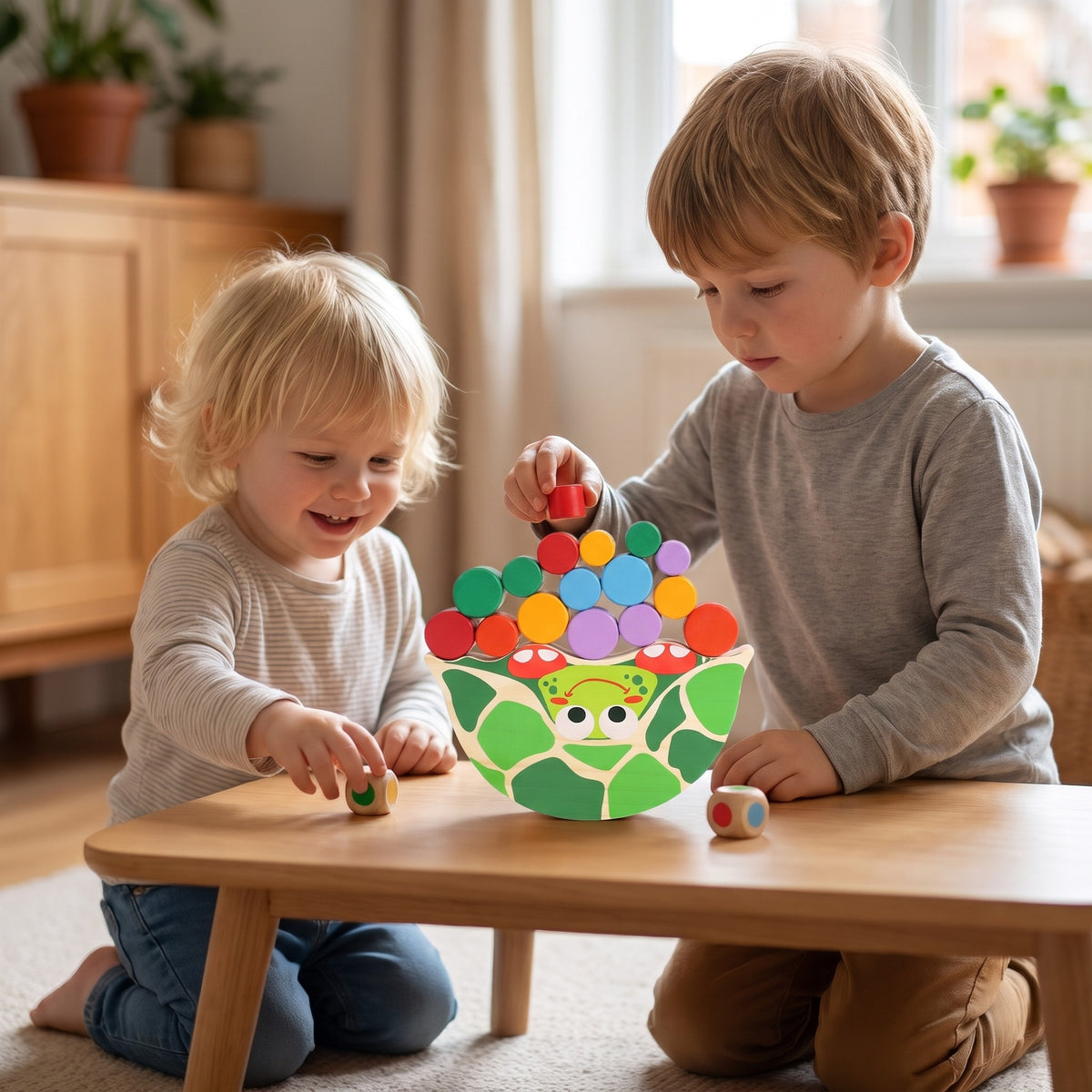 Two children rolling the colour dice and stacking pieces on the wooden tortoise