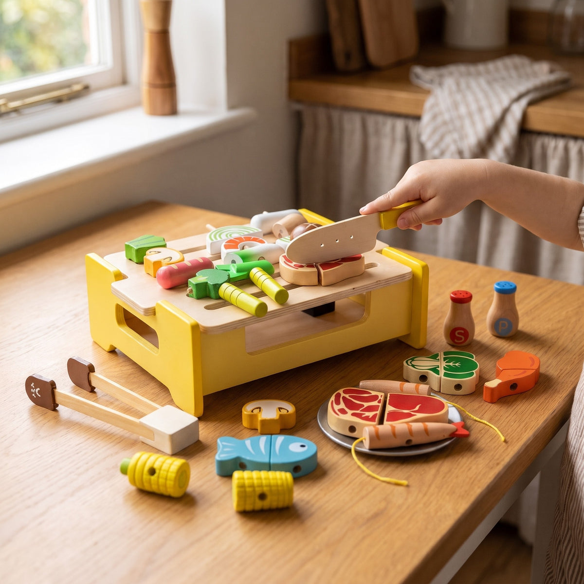 Child slicing wooden play food on the barbecue grill with the wooden knife