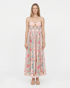 Woman wearing a floral pink dress on a white background