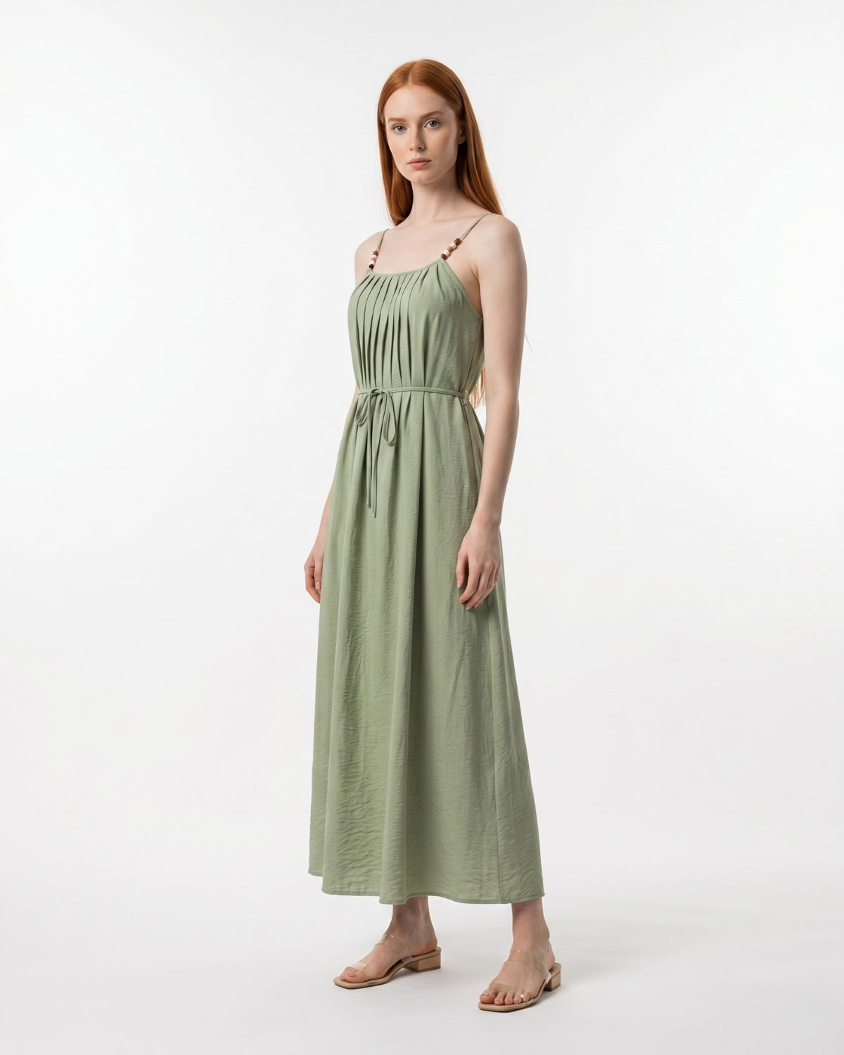 Woman wearing a green dress on a white background