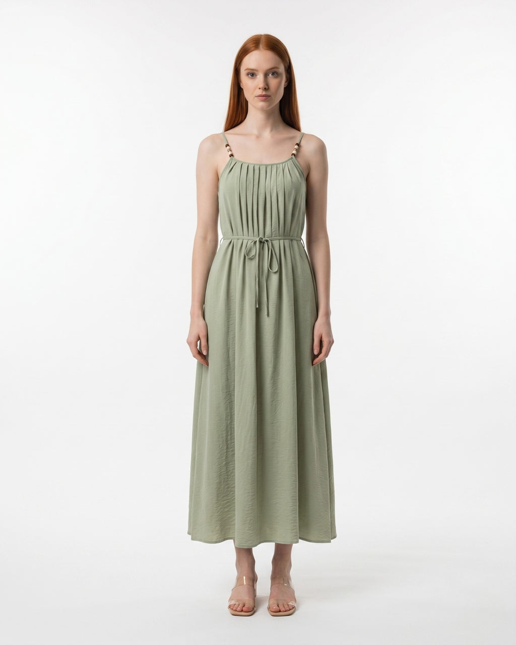 Woman wearing a green dress on a white background