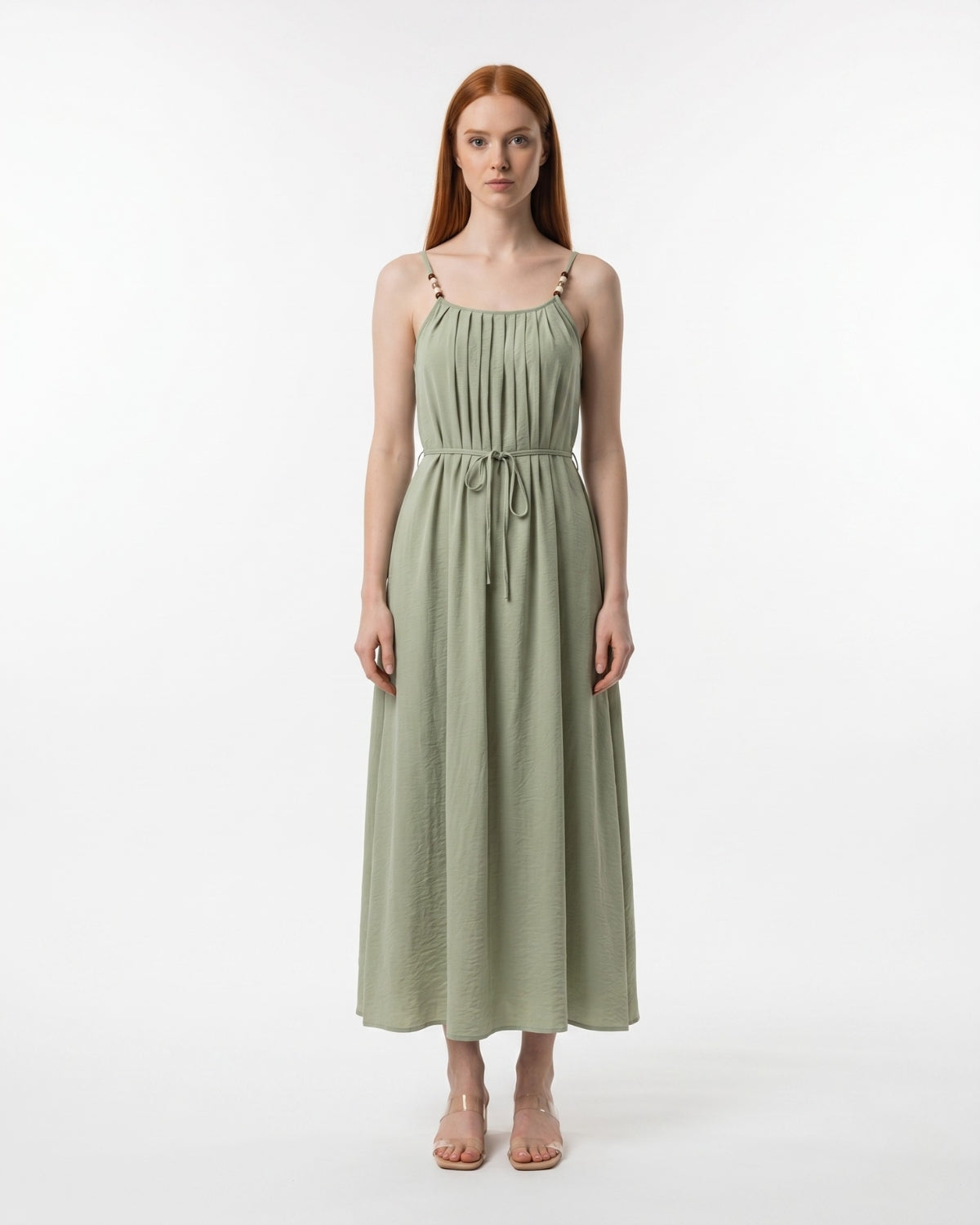 Woman wearing a green dress on a white background