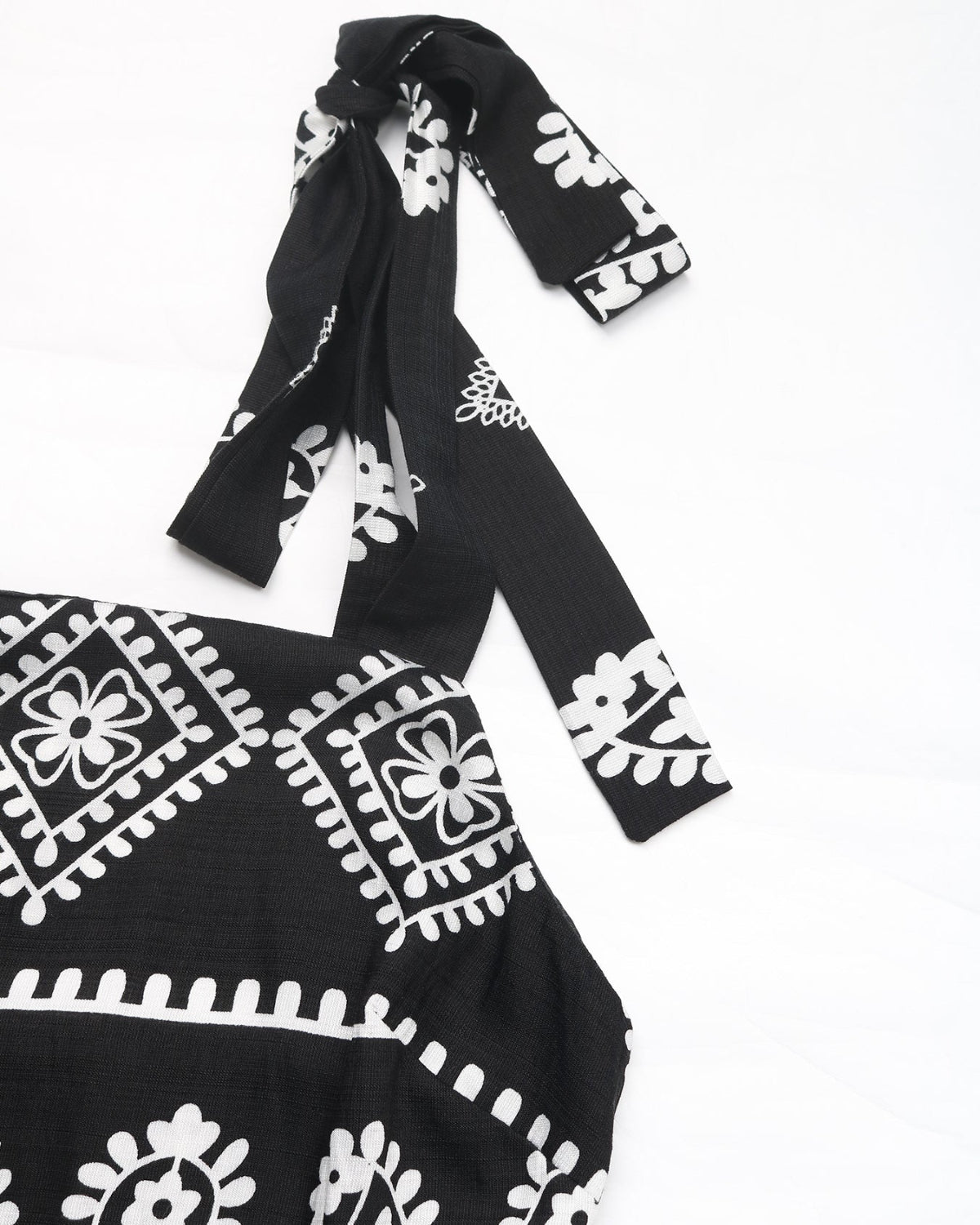 Black dress with white patterns on a white background
