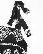 Black dress with white patterns on a white background