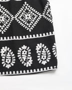 Black fabric with white geometric patterns on a white background
