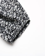 Black fabric with white floral pattern on a white background