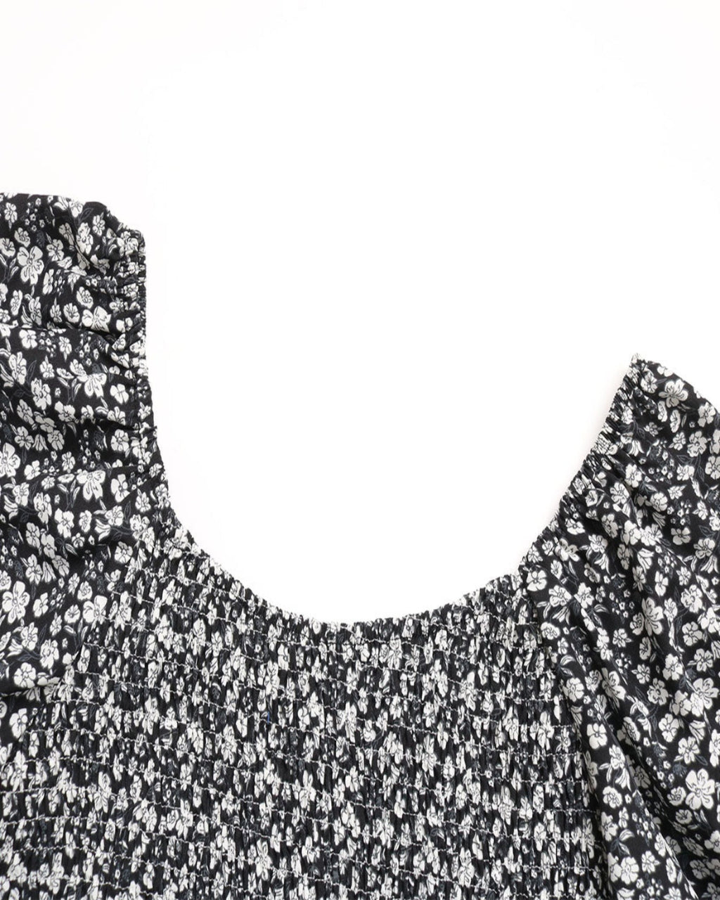 Black floral patterned top on a white background