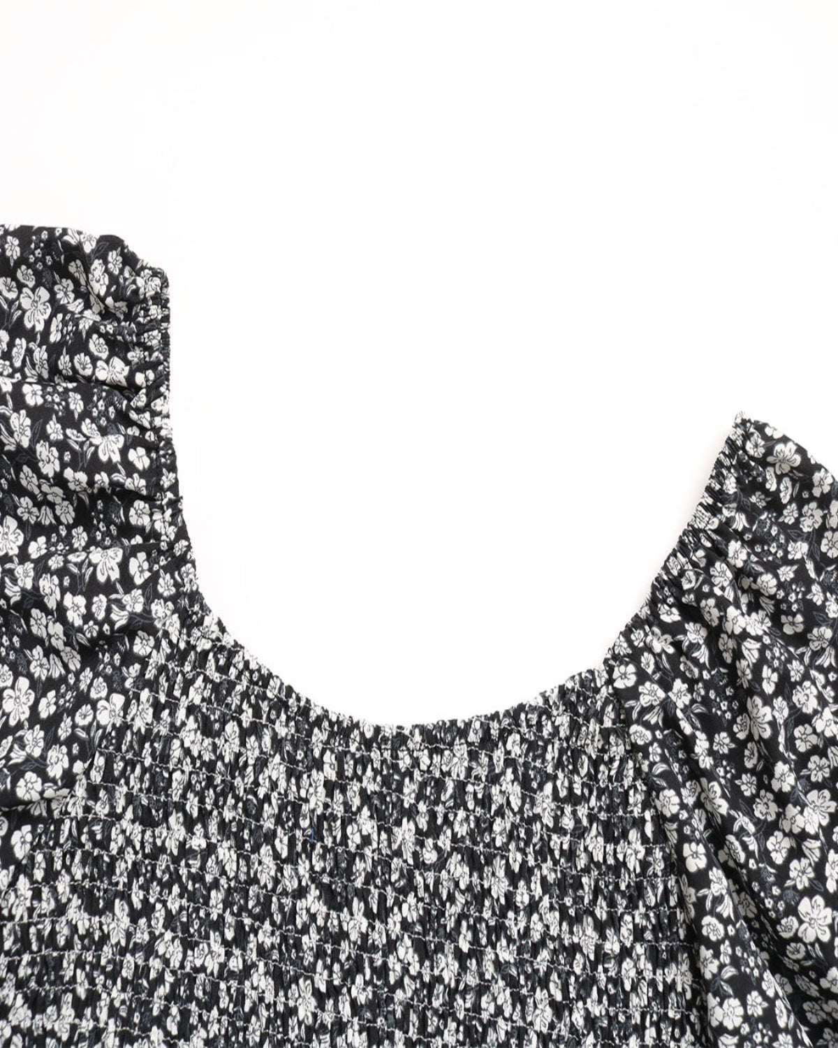Black floral patterned top on a white background