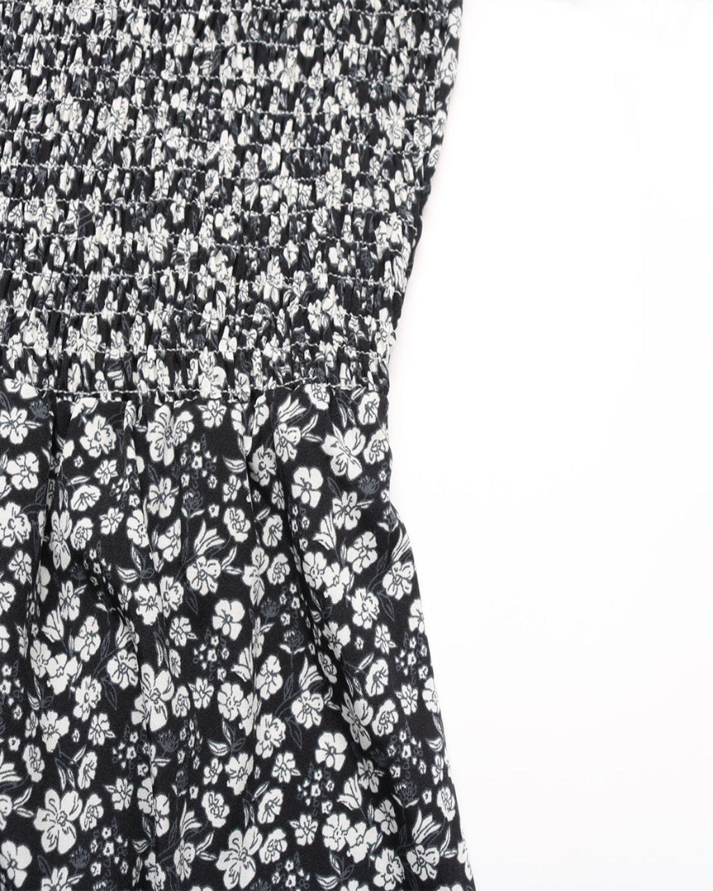 Black dress with white floral pattern on a white background