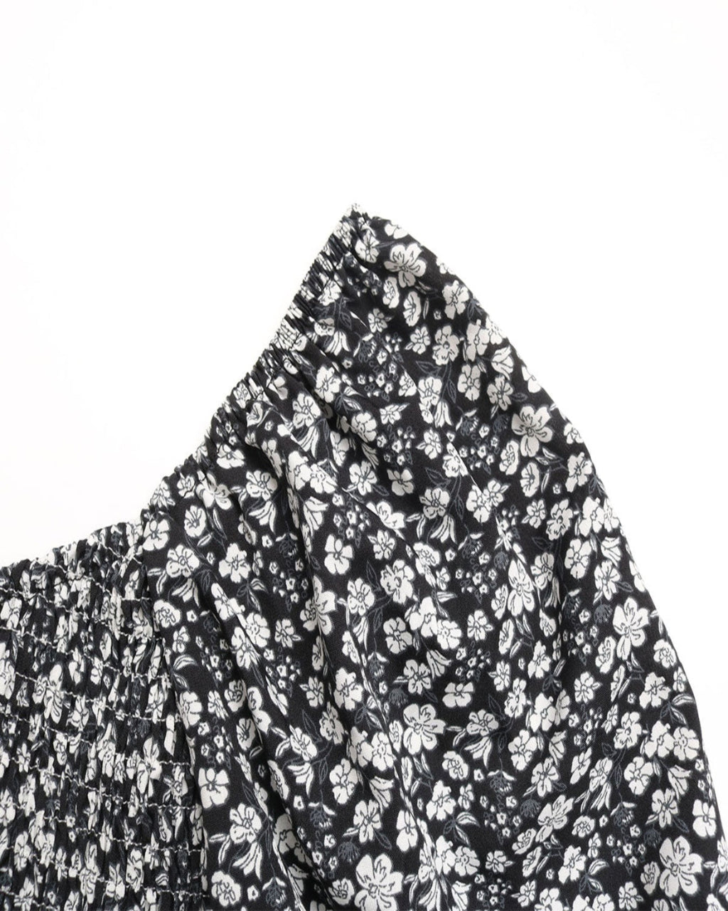 Black fabric with white floral pattern on a white background