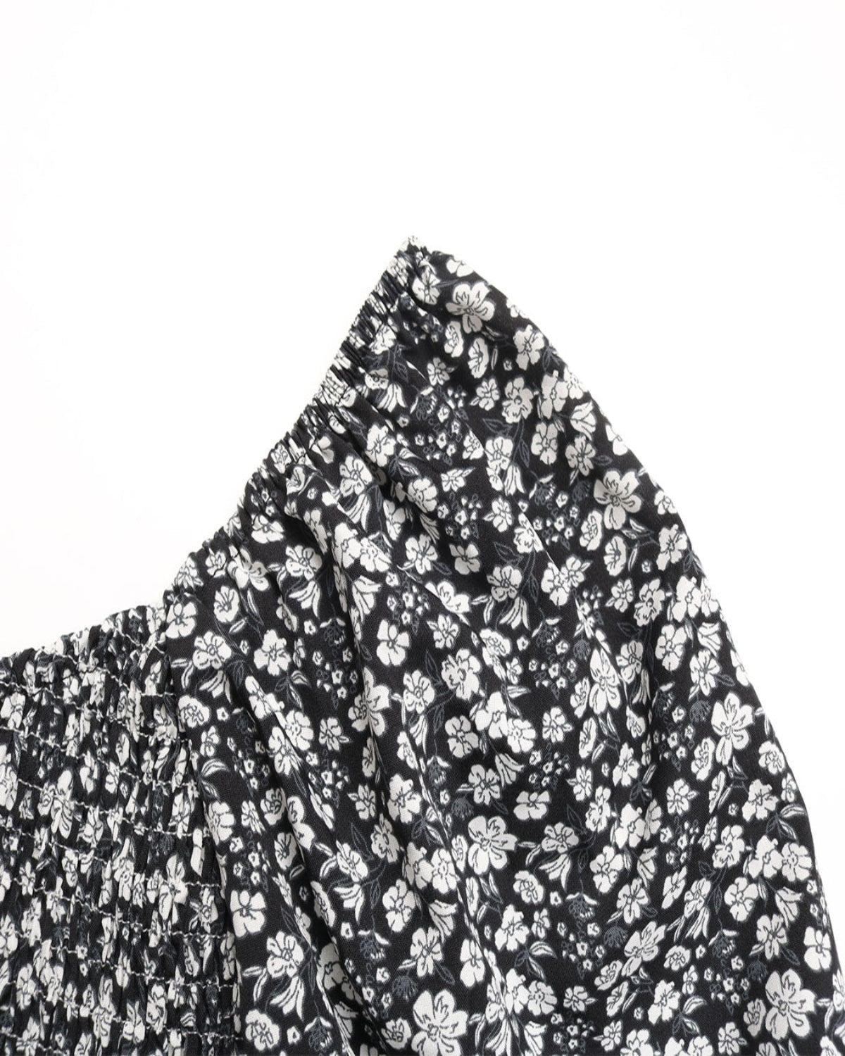 Black fabric with white floral pattern on a white background
