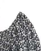 Black fabric with white floral pattern on a white background