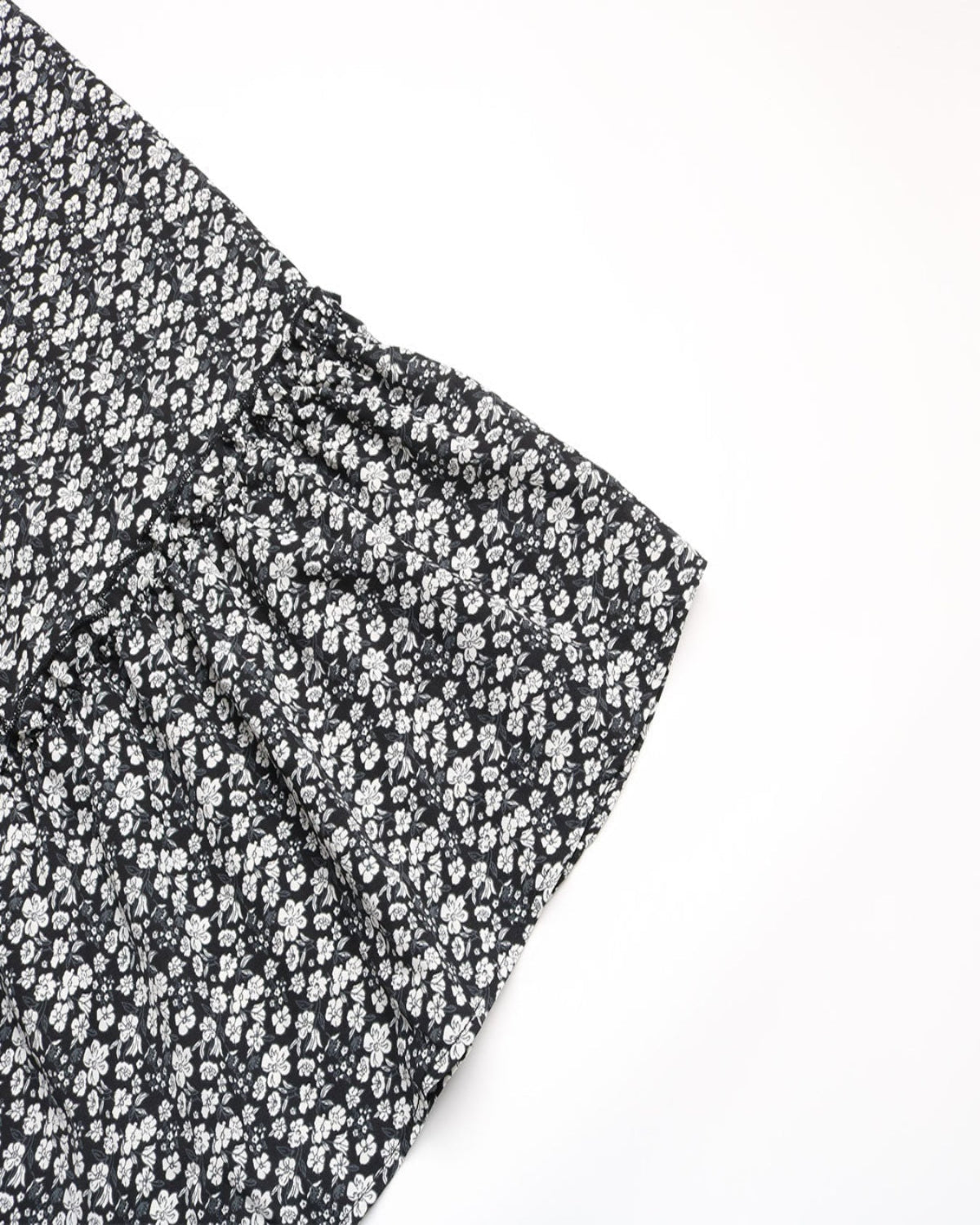 Black and white floral patterned fabric on a white background