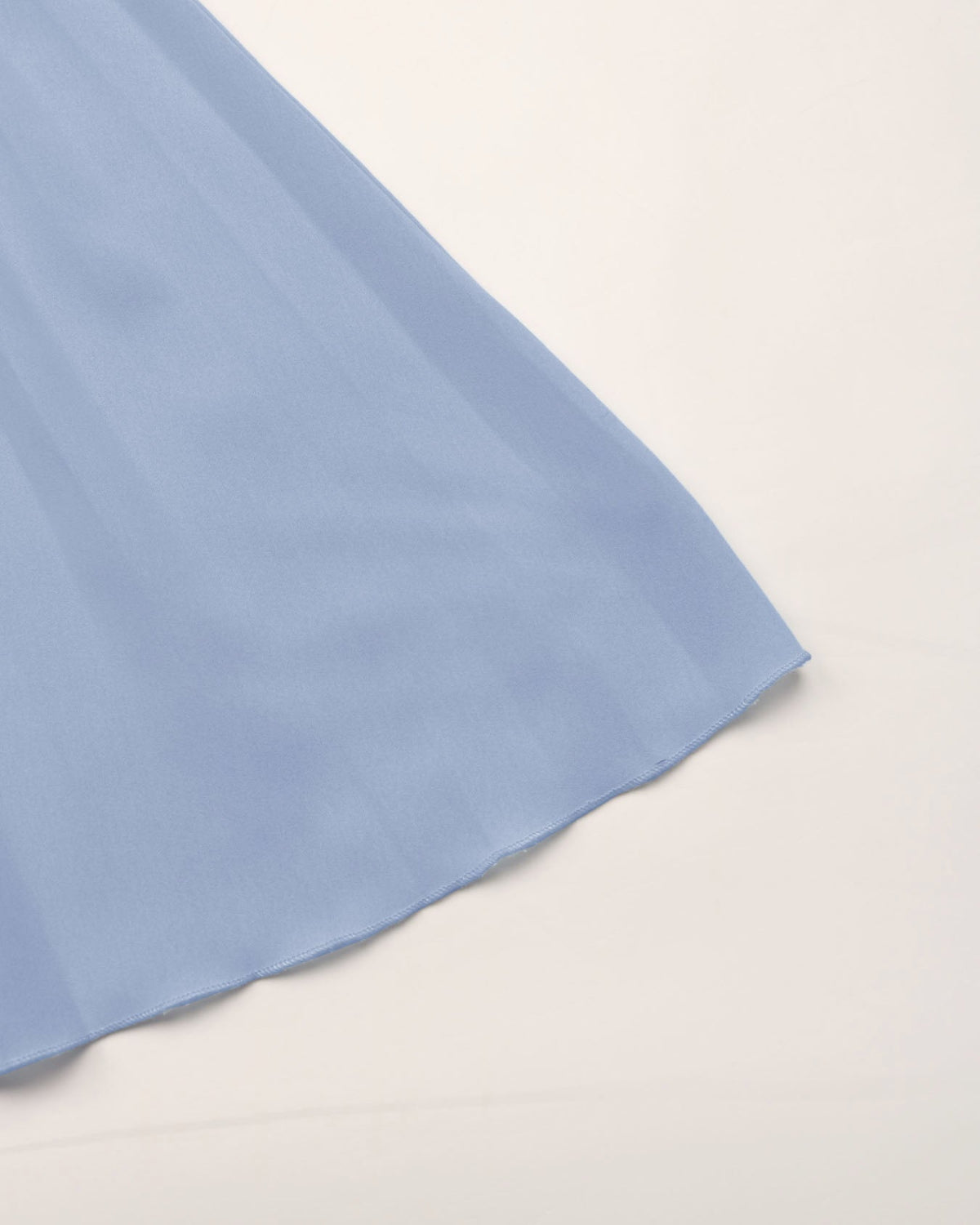 Light blue fabric corner on a beige background