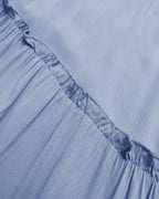 Close-up of a light blue fabric with ruffled edge