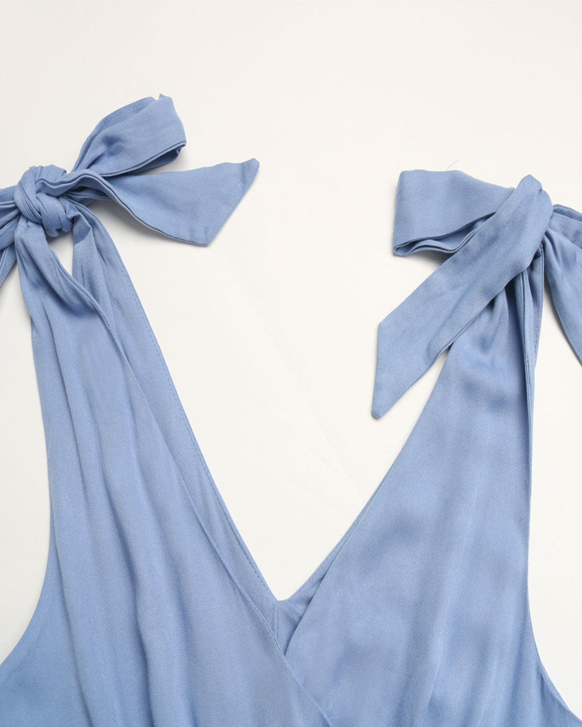 Light blue Maxi summer Dress with tied straps on a white background