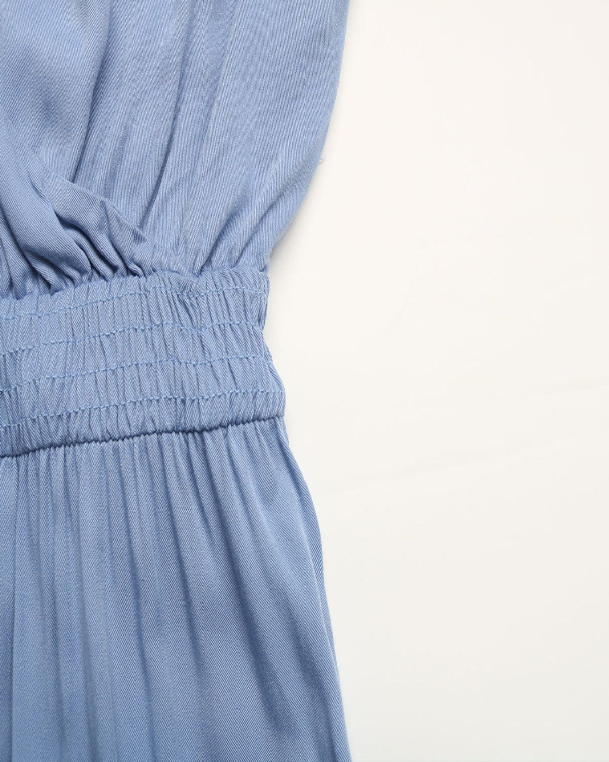 Close-up of a blue dress with a white background