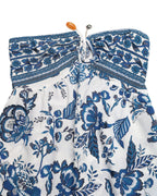 White strapless top with blue floral pattern on a white background