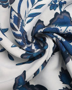 Close-up of blue and black floral patterned fabric on white background