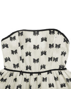 White strapless dress with black butterfly patterns on a white background