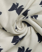 Close-up of white fabric with navy blue floral patterns