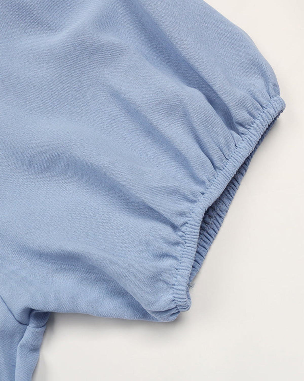 Light blue baby bloomers on a white background