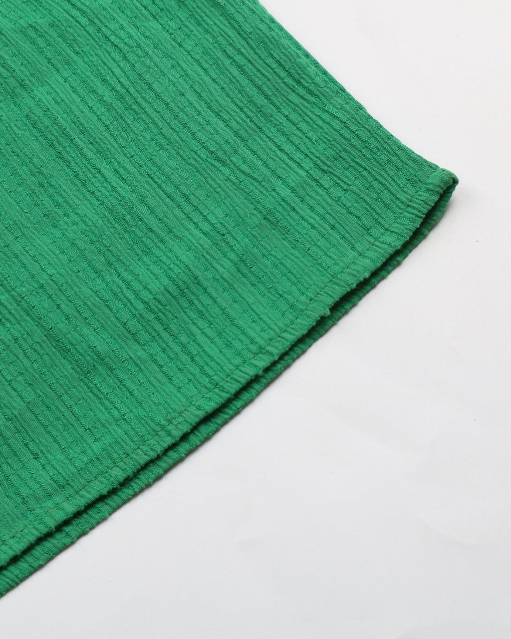 Close-up of a green textured fabric on a white background