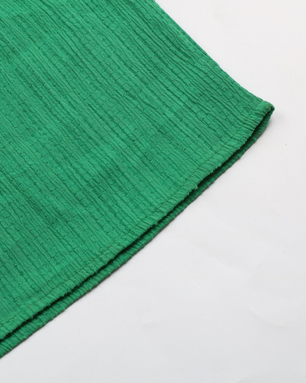 Close-up of a green textured fabric on a white background