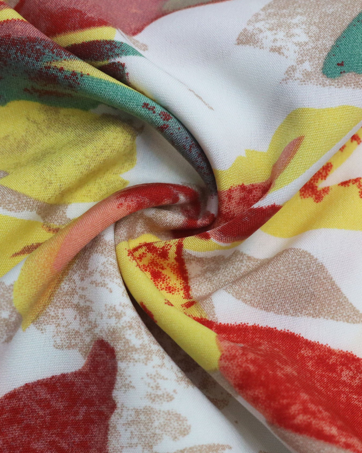 Close-up of colorful fabric with red, yellow, and green patterns.