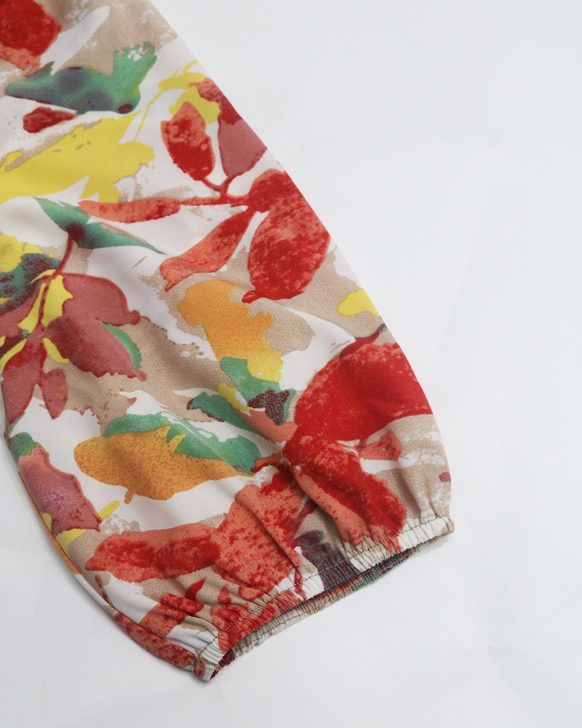 Colorful headscarf with autumn leaf pattern on a white background