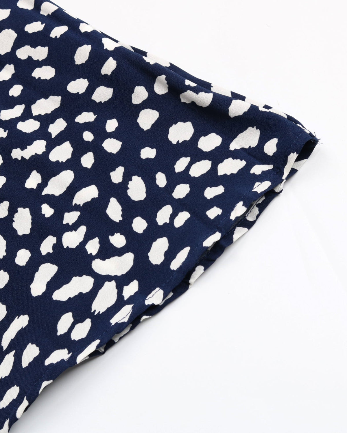 Navy fabric with white abstract pattern on a white background