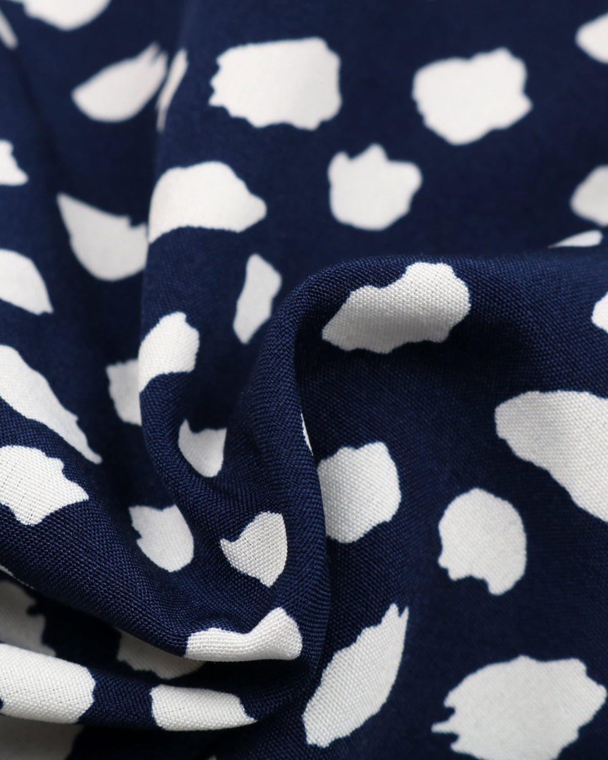 Navy blue fabric with white abstract pattern