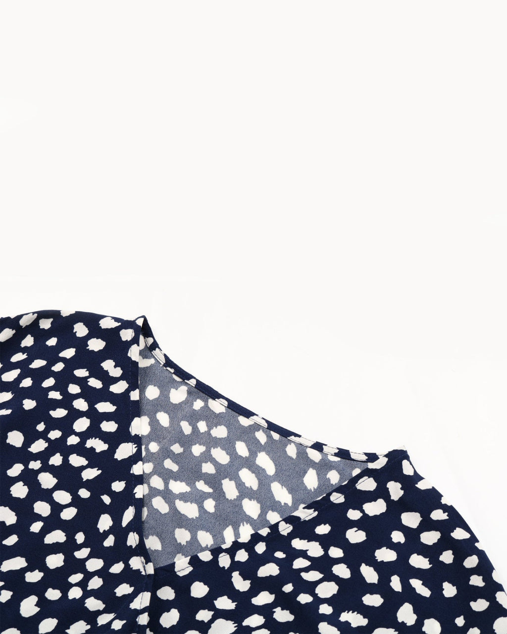 Navy blue fabric with white polka dot pattern on a white background