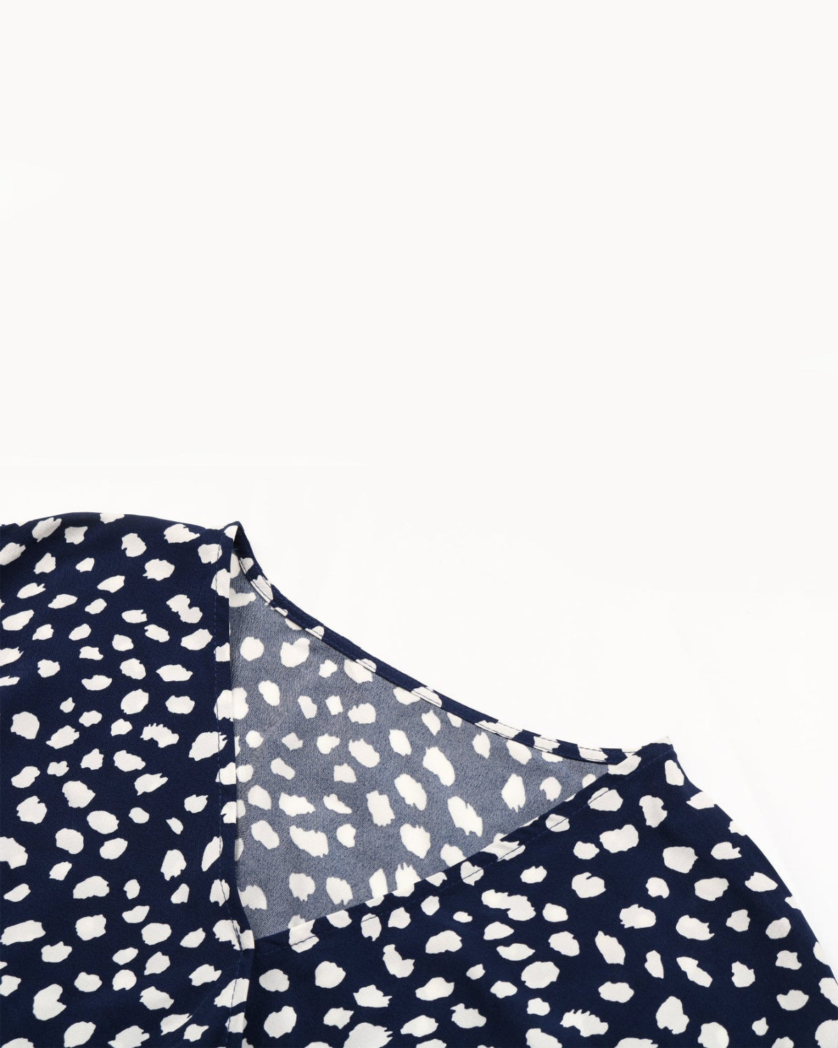 Navy blue fabric with white polka dot pattern on a white background