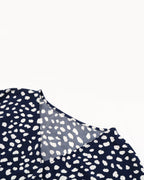 Navy blue fabric with white polka dot pattern on a white background