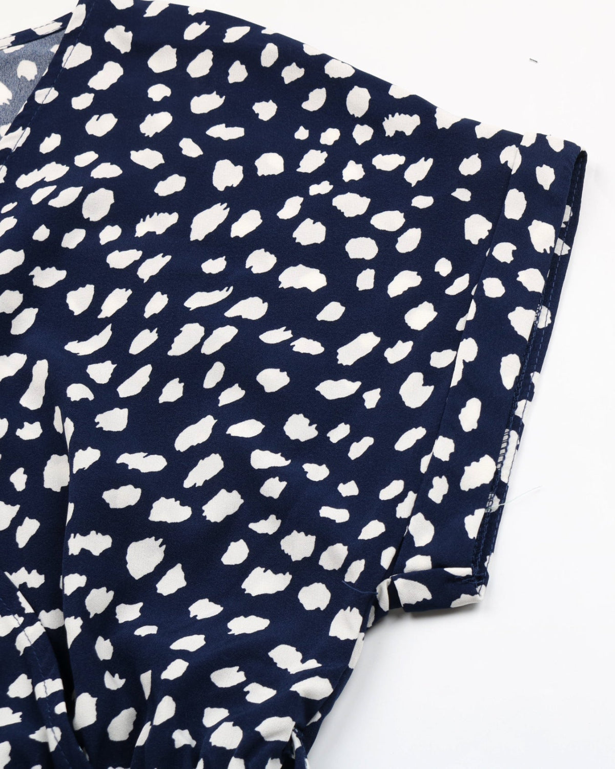 Navy blue fabric with white polka dot pattern on a white background