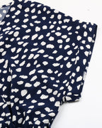 Navy blue fabric with white polka dot pattern on a white background