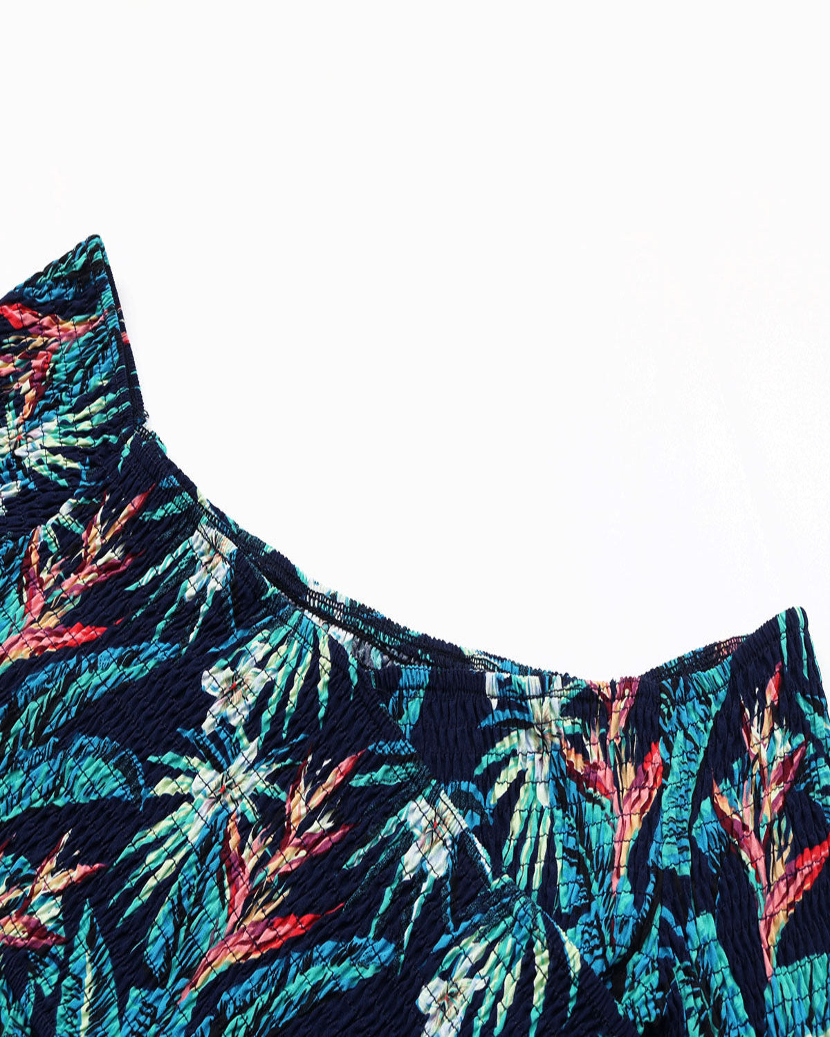Close-up of a colorful tropical leaf patterned fabric on a white background