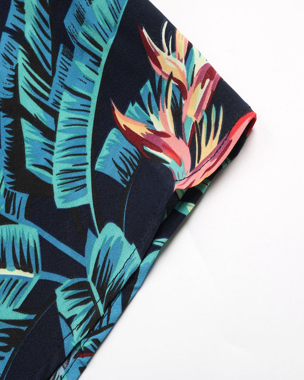 Tropical leaf patterned fabric with a white background