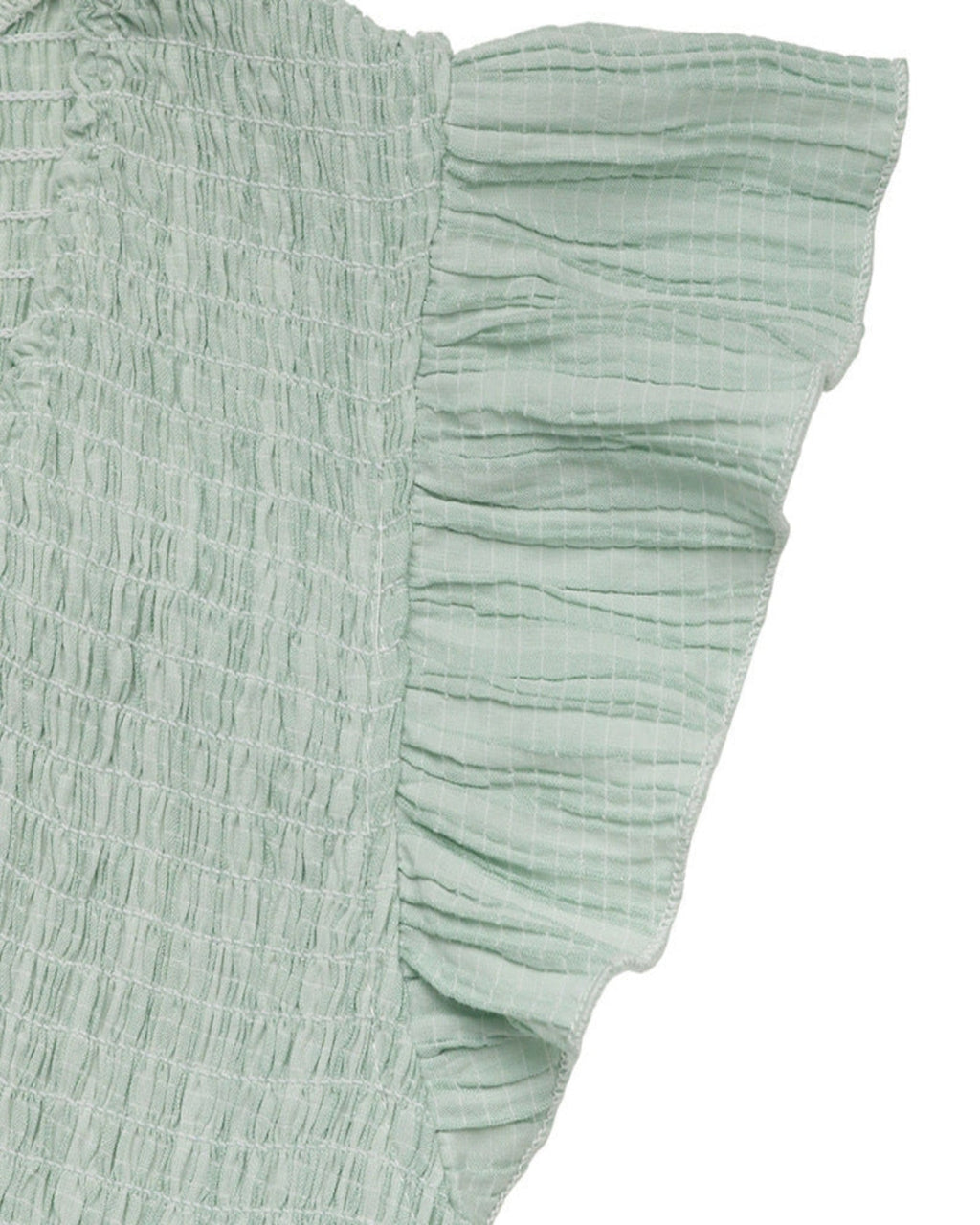 Light green textured fabric with ruffled edge on a white background