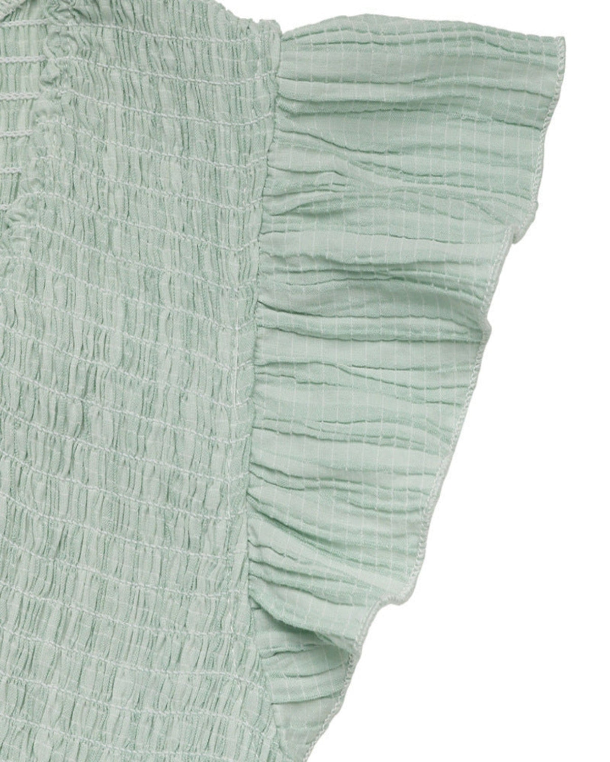 Light green textured fabric with ruffled edge on a white background