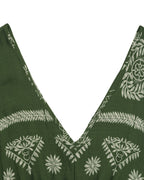 Green dress with white floral patterns on a white background