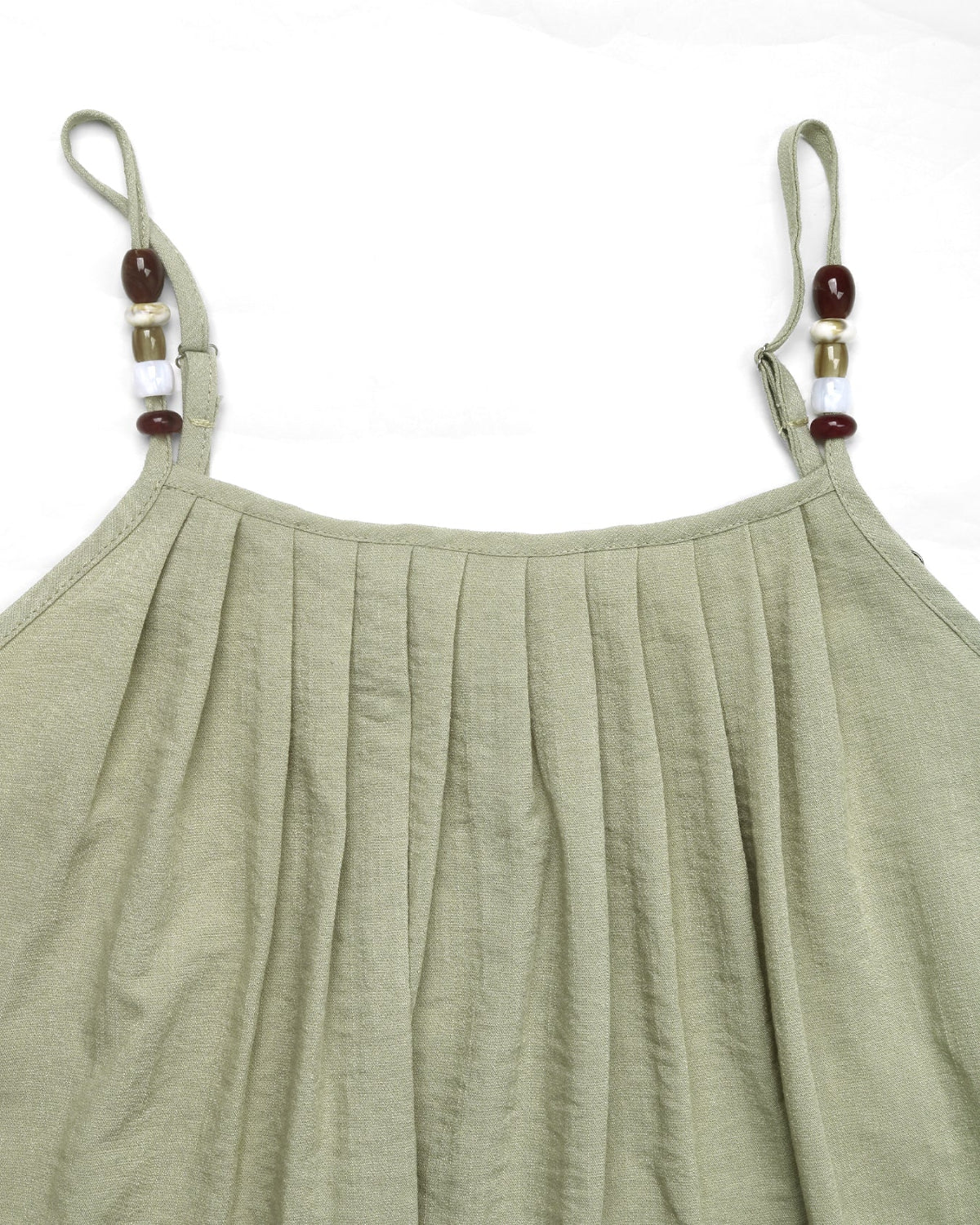 Green pleated dress with thin straps and bead details on a white background