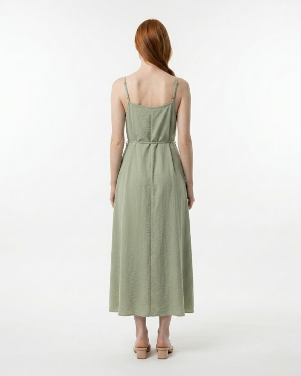 Woman wearing a green dress on a white background